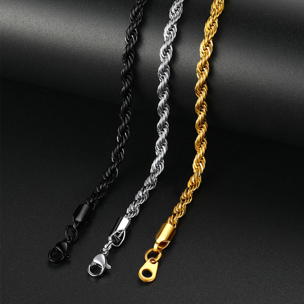 Three chain necklaces in black, silver, and gold on a dark background