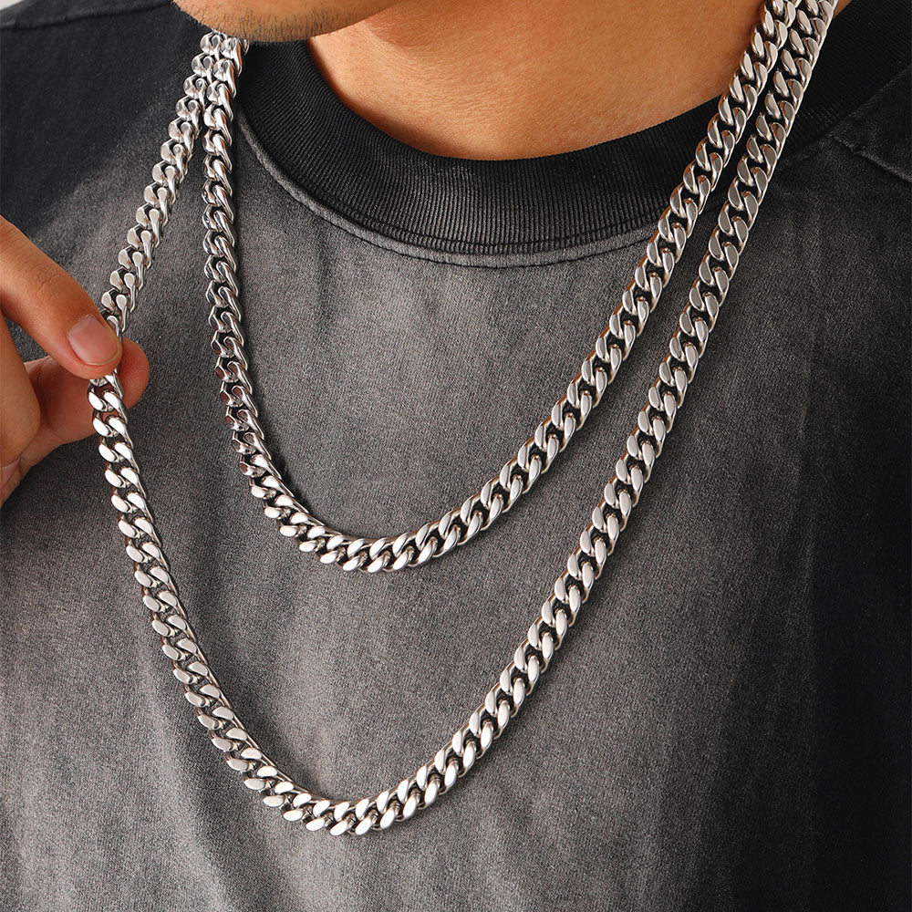 Person wearing two silver chain necklace