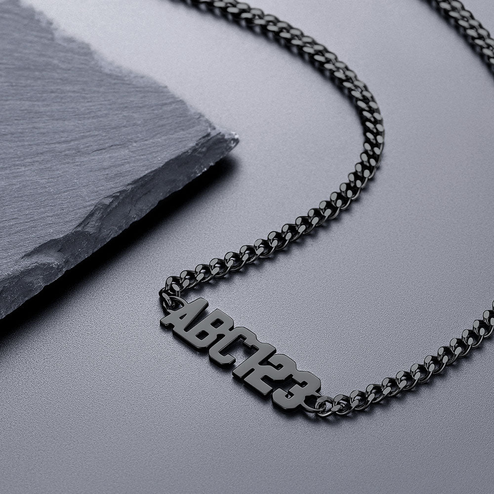 Black chain necklace with 'ABCD123' pendant on a dark surface