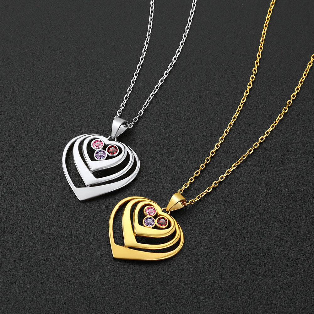 Two heart-shaped birthstone pendants, one gold and one silver