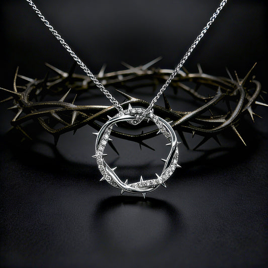 Silver Crown Of Thorns Pendant necklace with a circular pendant on a dark backgroundimg