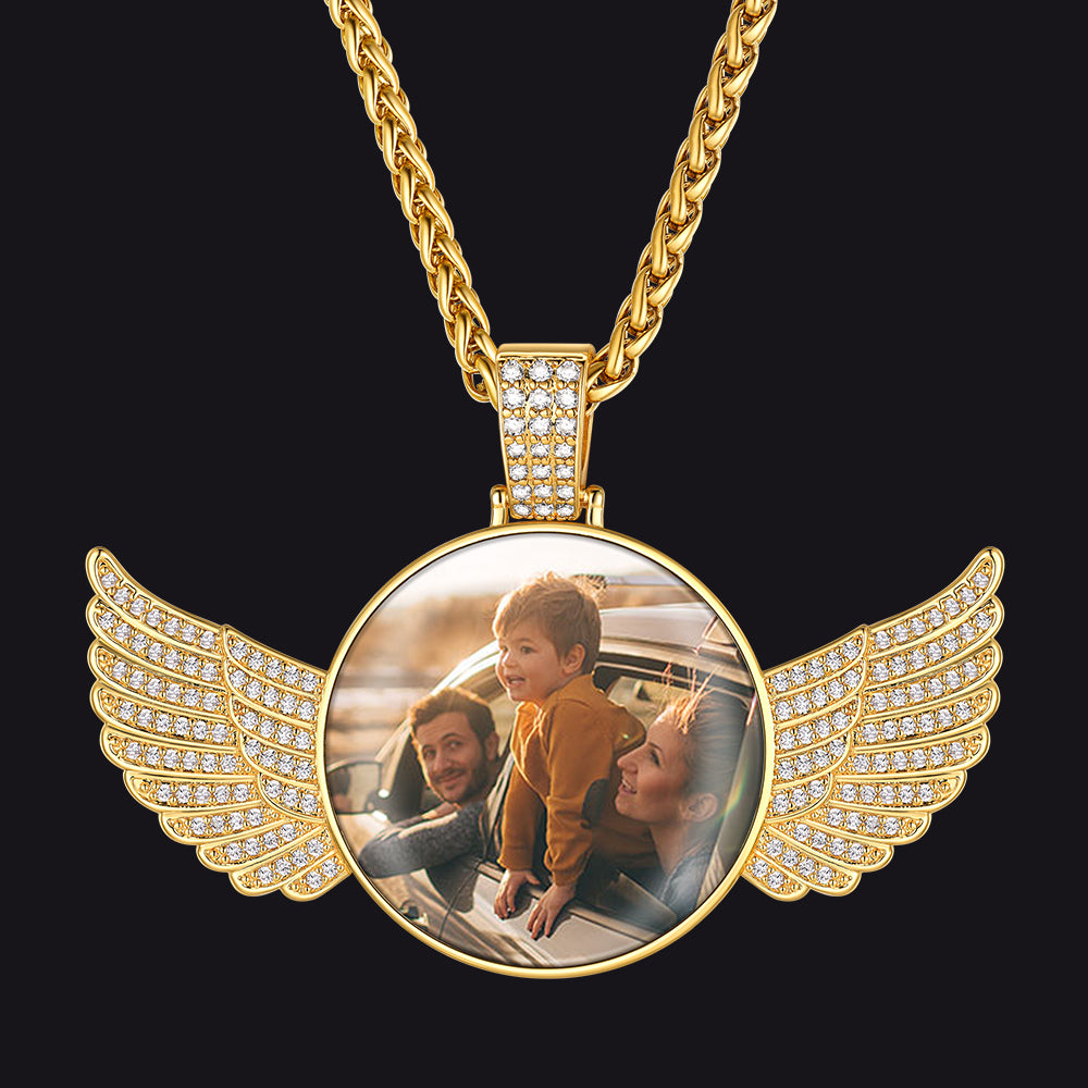 Gold winged pendant with a circular photo insert