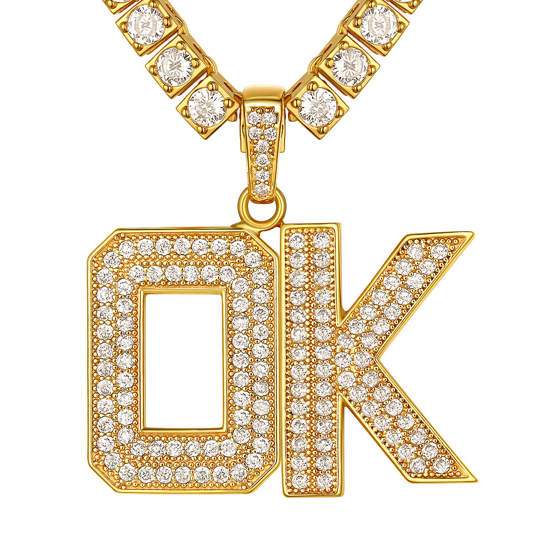 Gold necklace with 'OK' pendant featuring diamonds on a white background