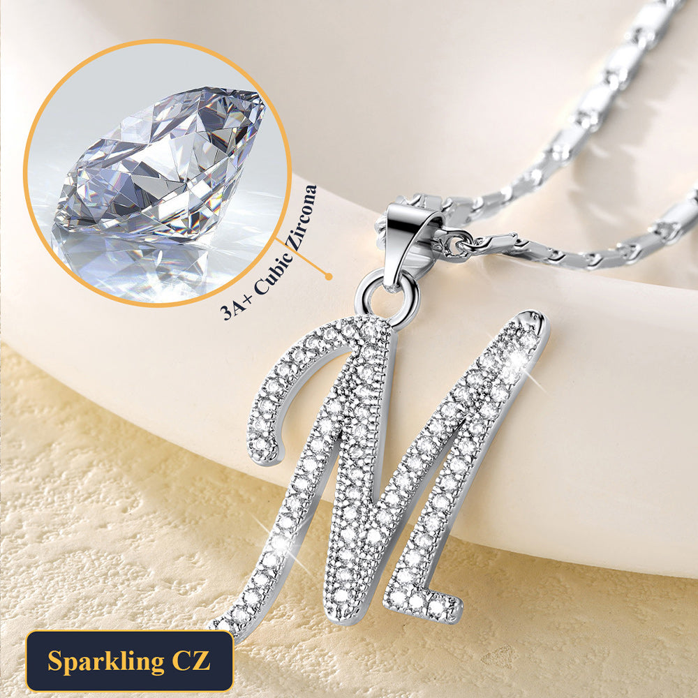 Close-up of sparkling CZ crystal initial pendant in gold.