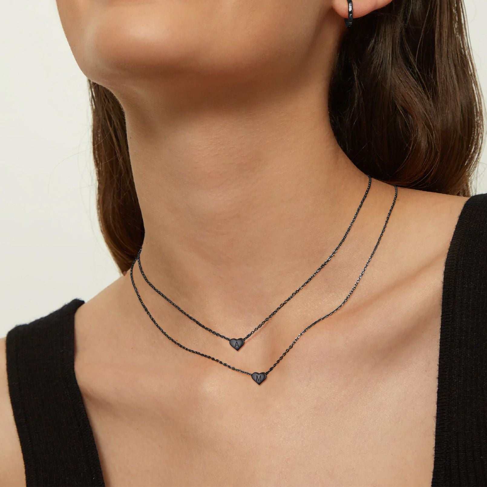 A Woman Wearing Sterling Silver Initial Heart Charm Necklace