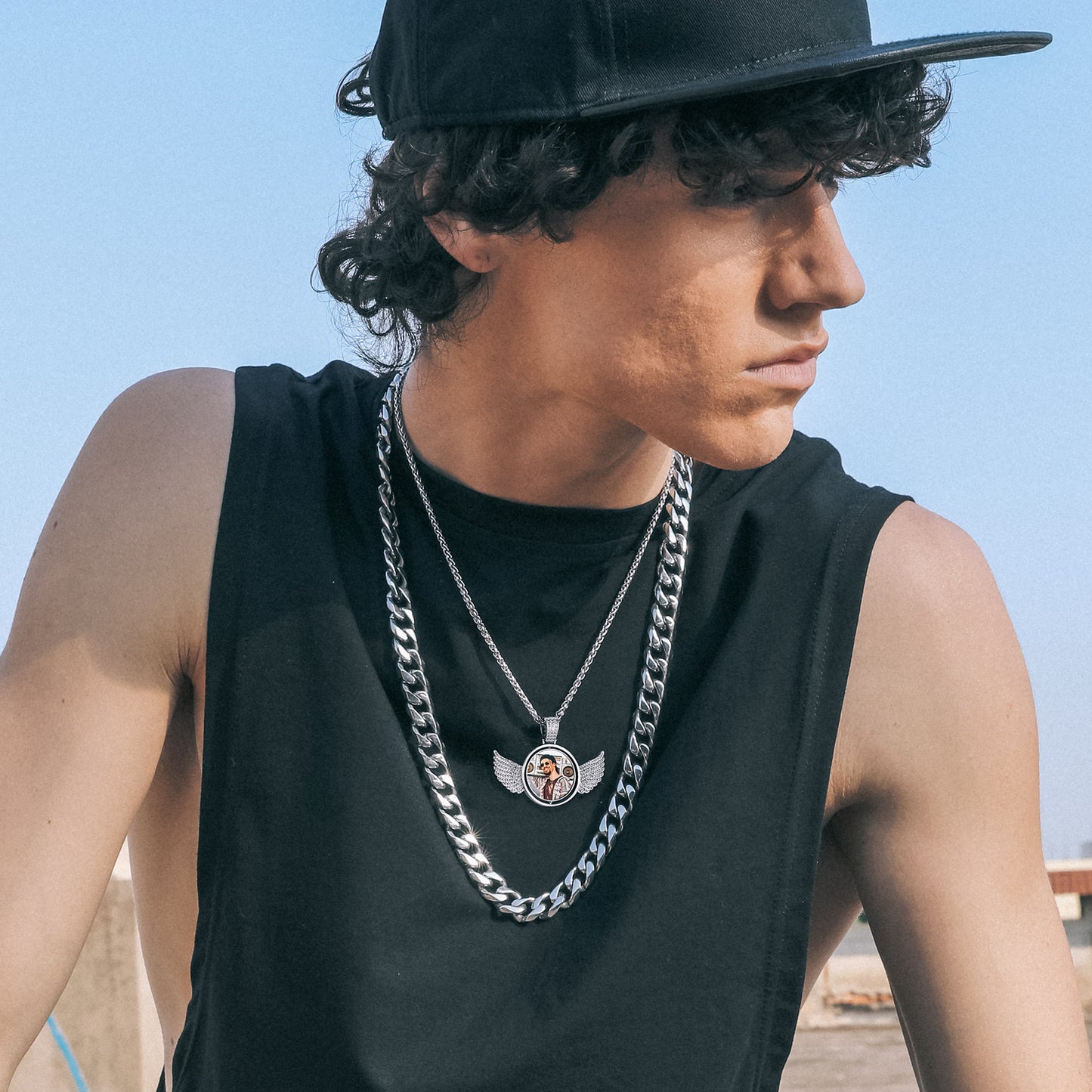 Man wearing custom angel wing photo necklace, a personalized gift