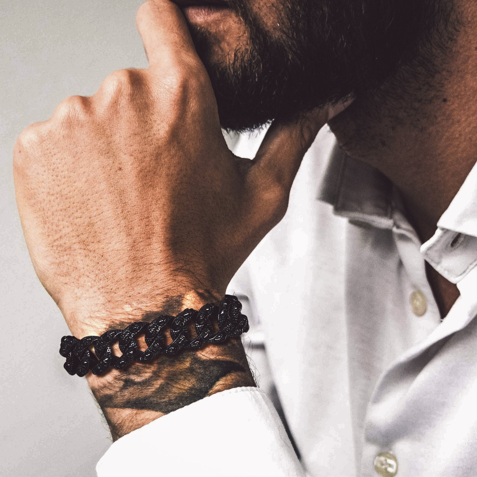 Man wearing chunky skull Cuban link chain bracelet
