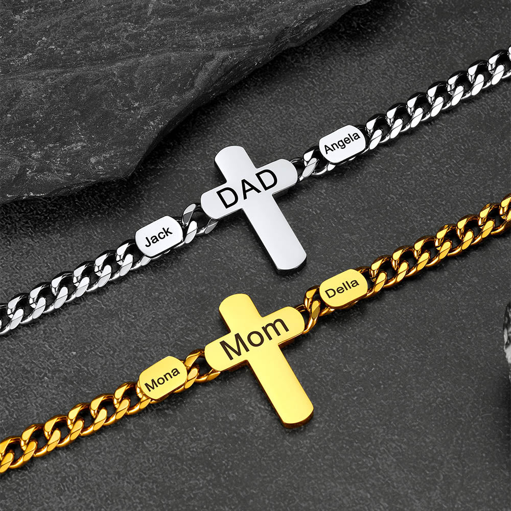 Two gold and silver cross-shaped bracelets with engraved names on a dark surface.