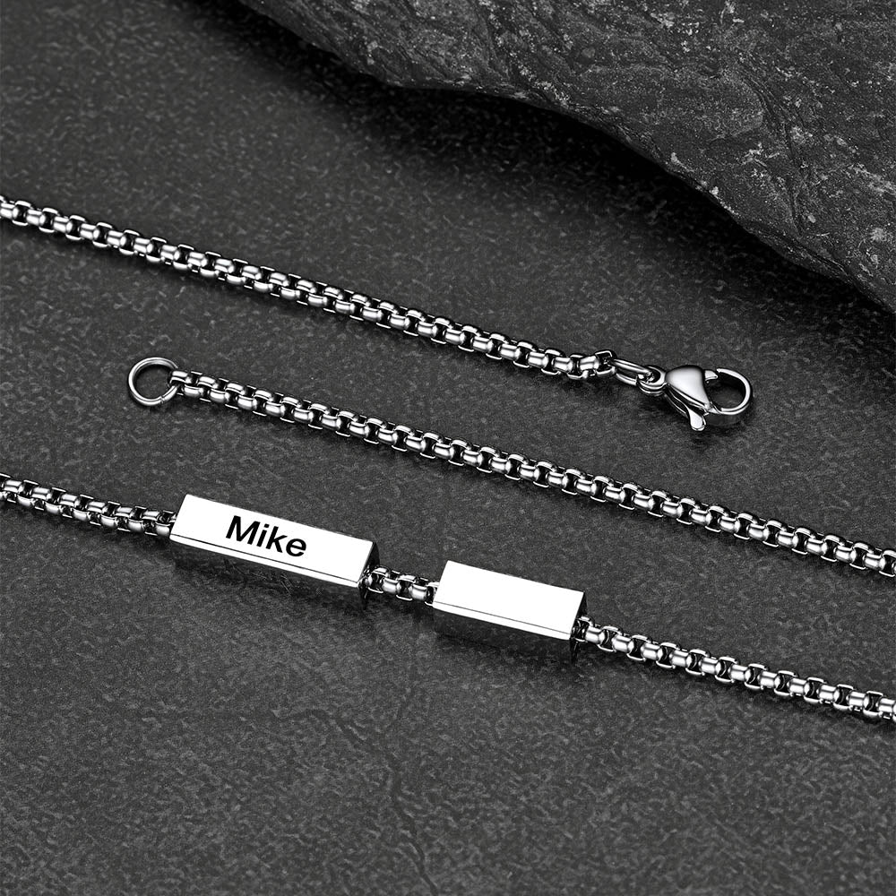 Detail of lobster clasp and Cuban link design in steel finish