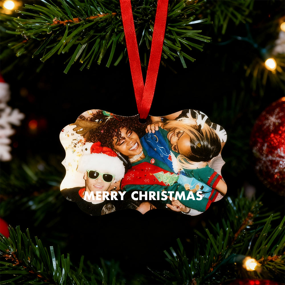 Heart-shaped photo ornament with four people on a Christmas tree.