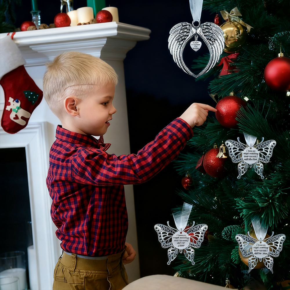 Child in a red plaid shirt decorating a Christmas tree with ornaments.