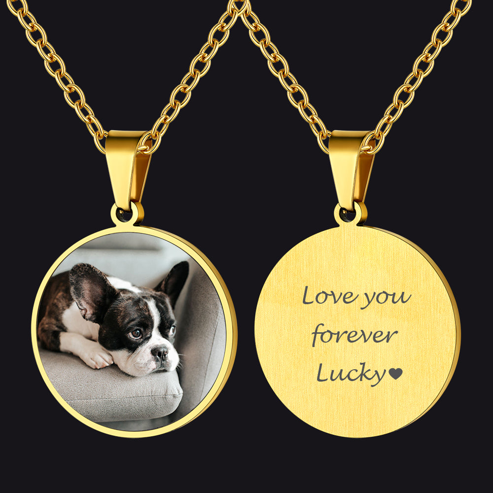 Gold pendant necklace with a photo of a dog and engraved message on a black background