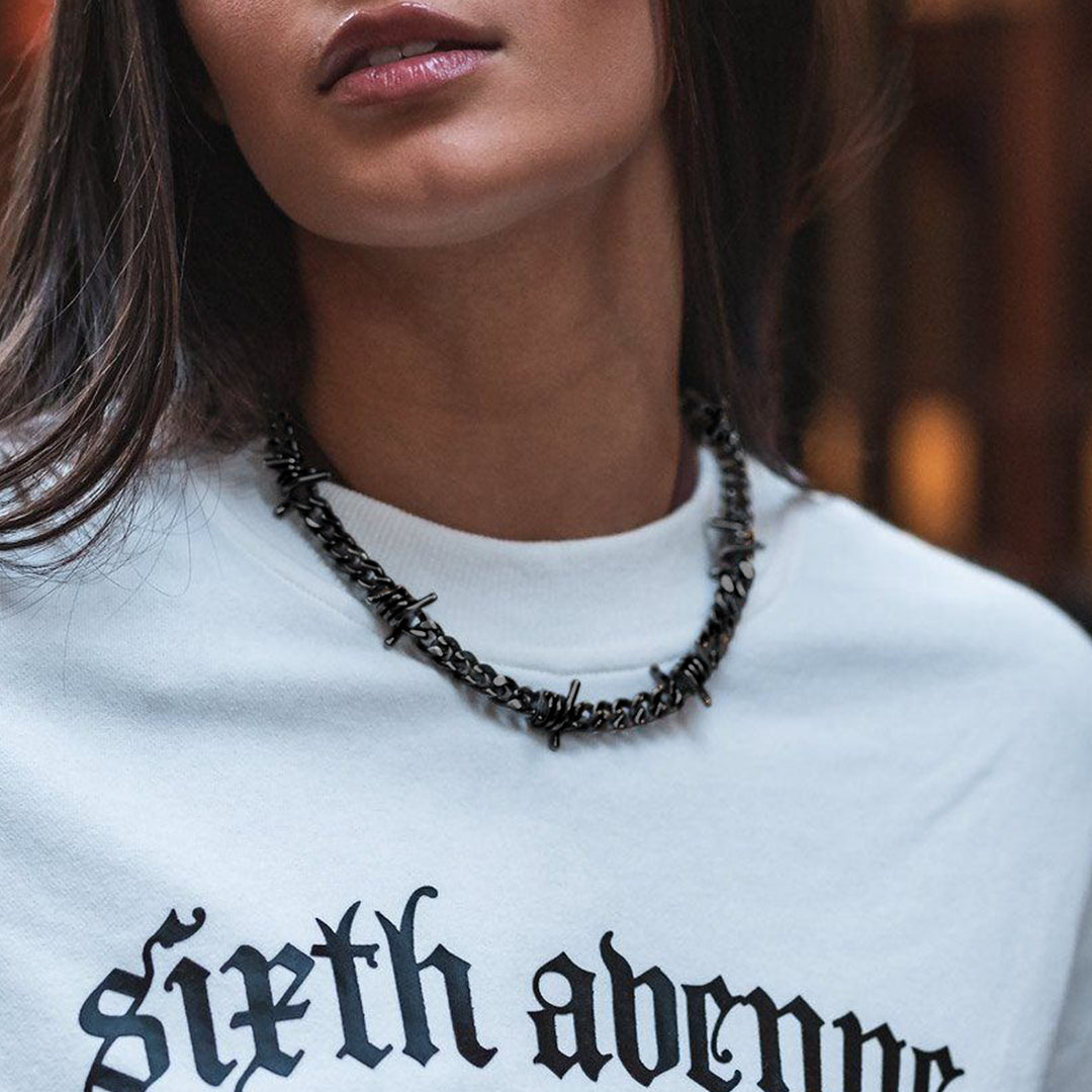 Black barbed wire Cuban link choker necklace on a woman
