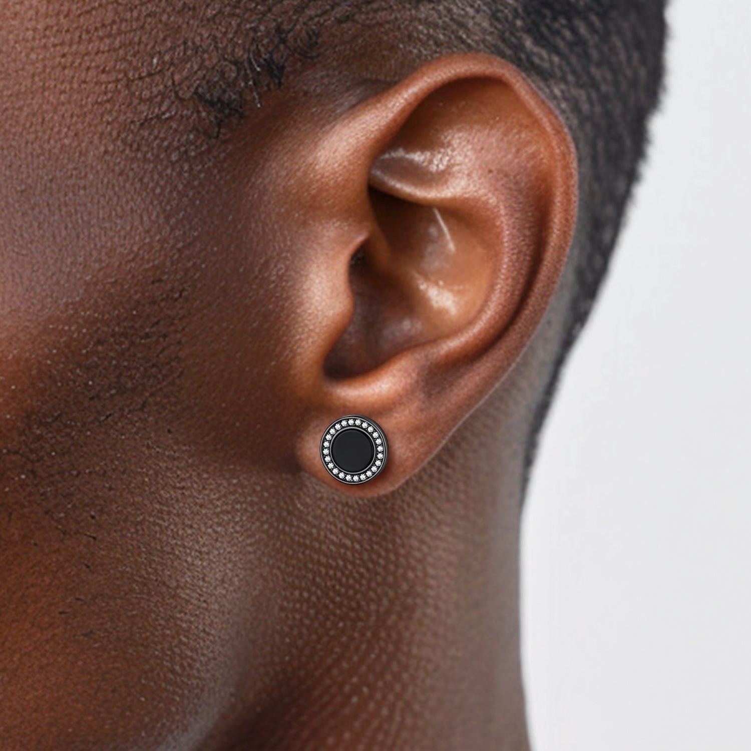 Black onyx stud earring on man's ear