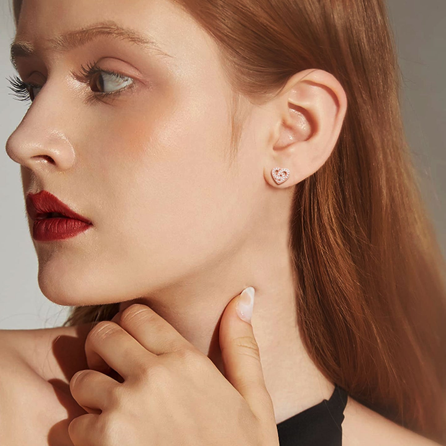 Woman wearing zirconia Celtic heart stud earrings