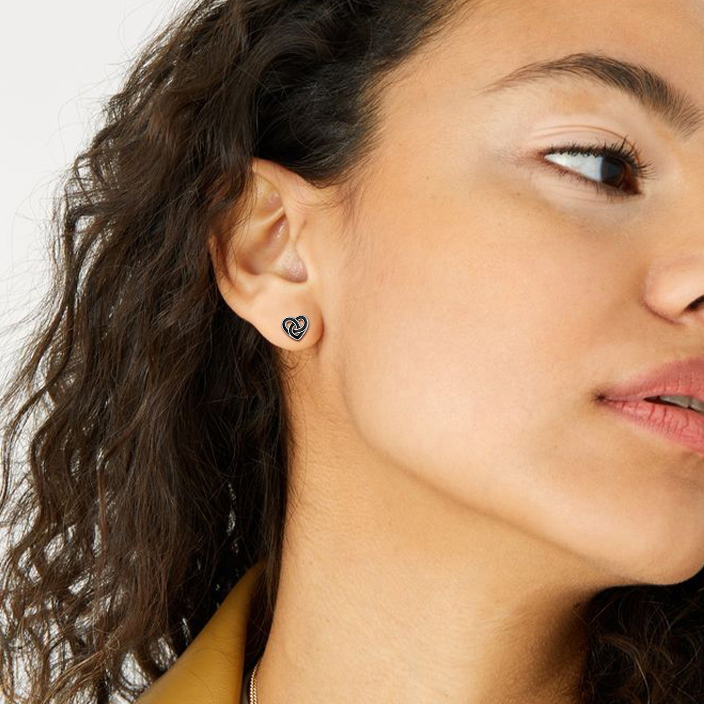 Woman wearing black Celtic knot heart stud earring
