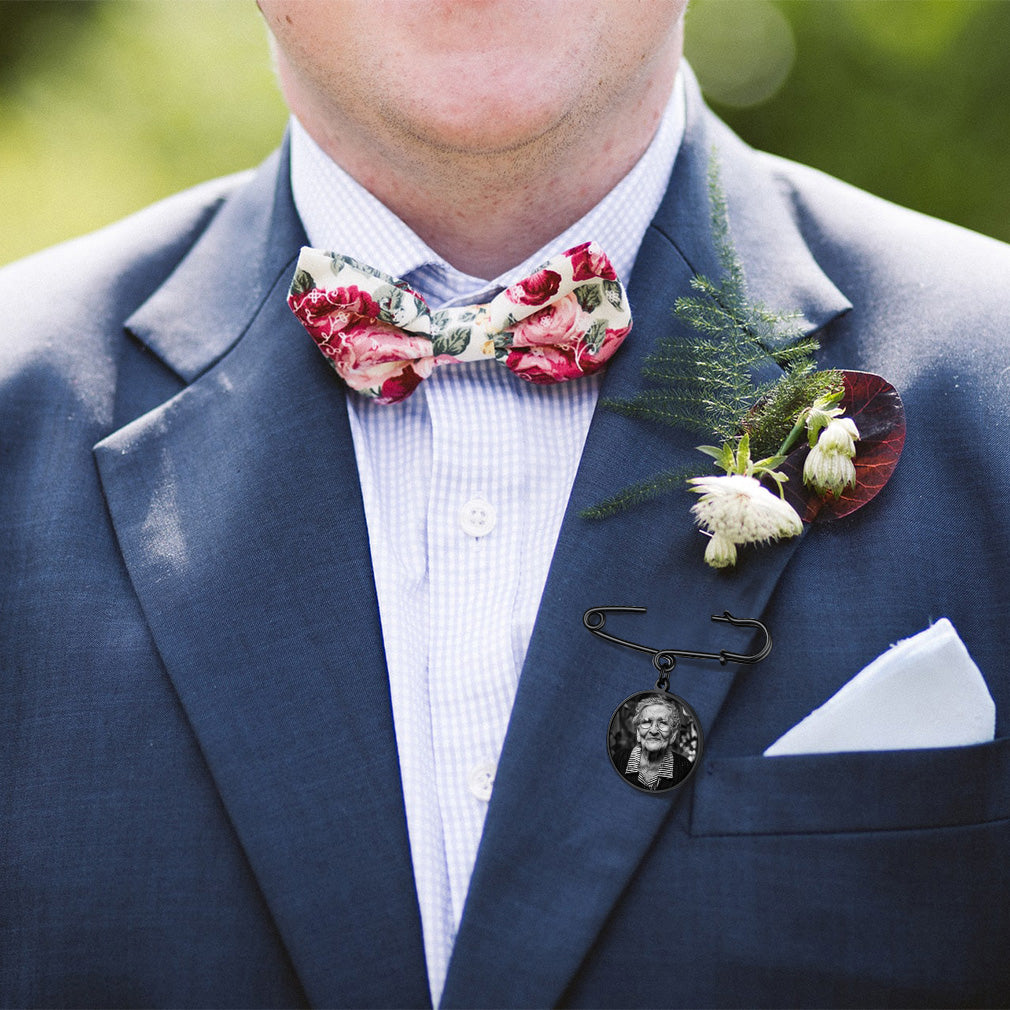 Memorial photo pin on groom's suit, wedding keepsake.