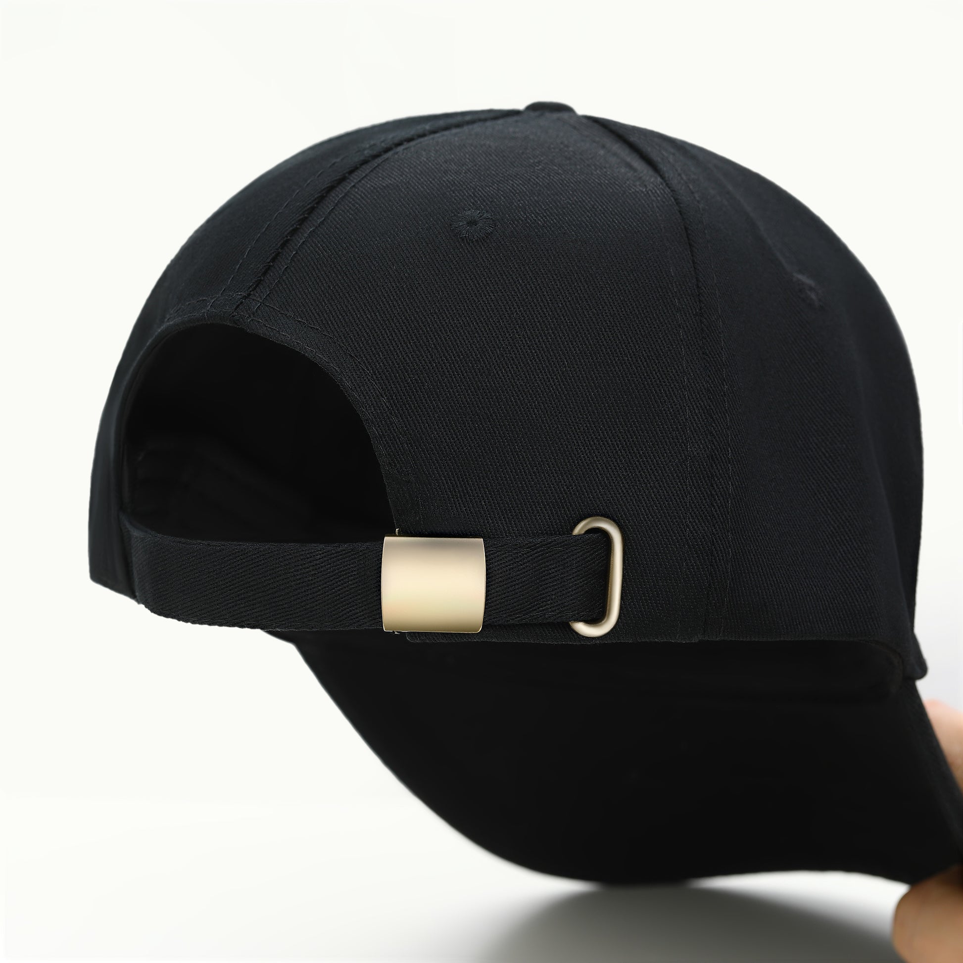 Black cap with a gold buckle on a white background