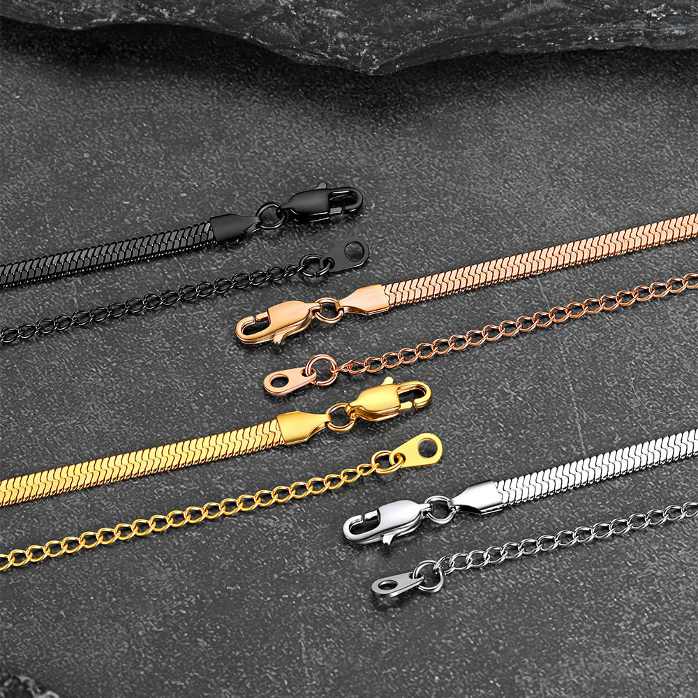 Close-up of engraved names snake chain with polished finish