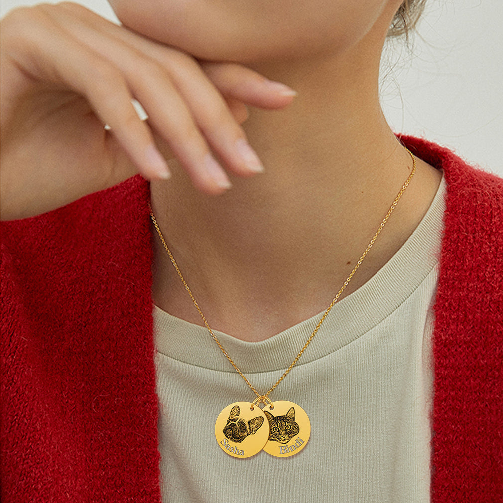 Woan wearing gold engraved dog pendant necklace, close to chest