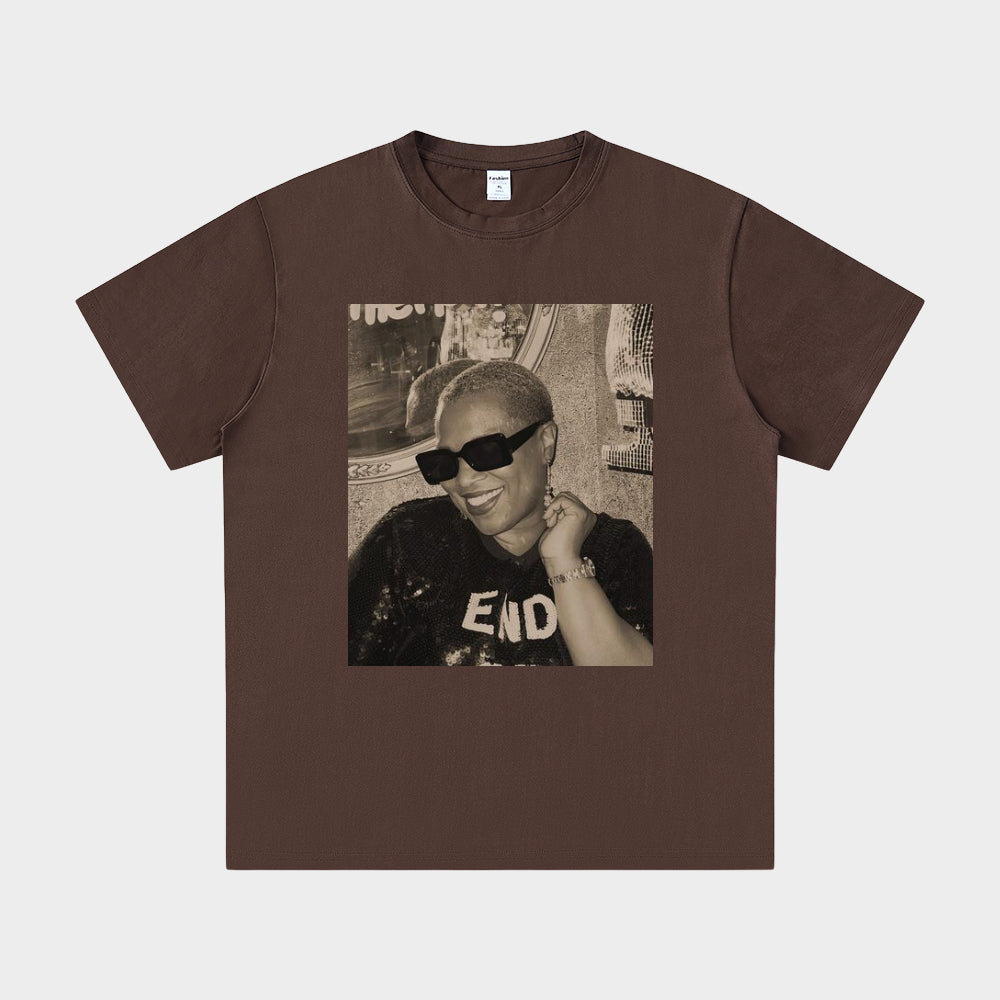 Brown t-shirt with a graphic of a person wearing sunglasses and a 'END' shirt on a white background