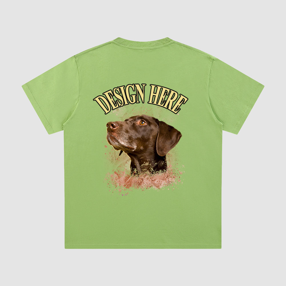 Green t-shirt with a dog graphic and 'Design Here' text on a light gray background