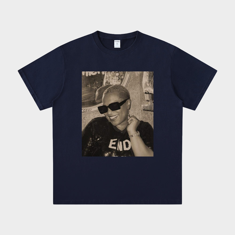 Navy blue t-shirt with a graphic of a person wearing sunglasses and a hat on a light gray background