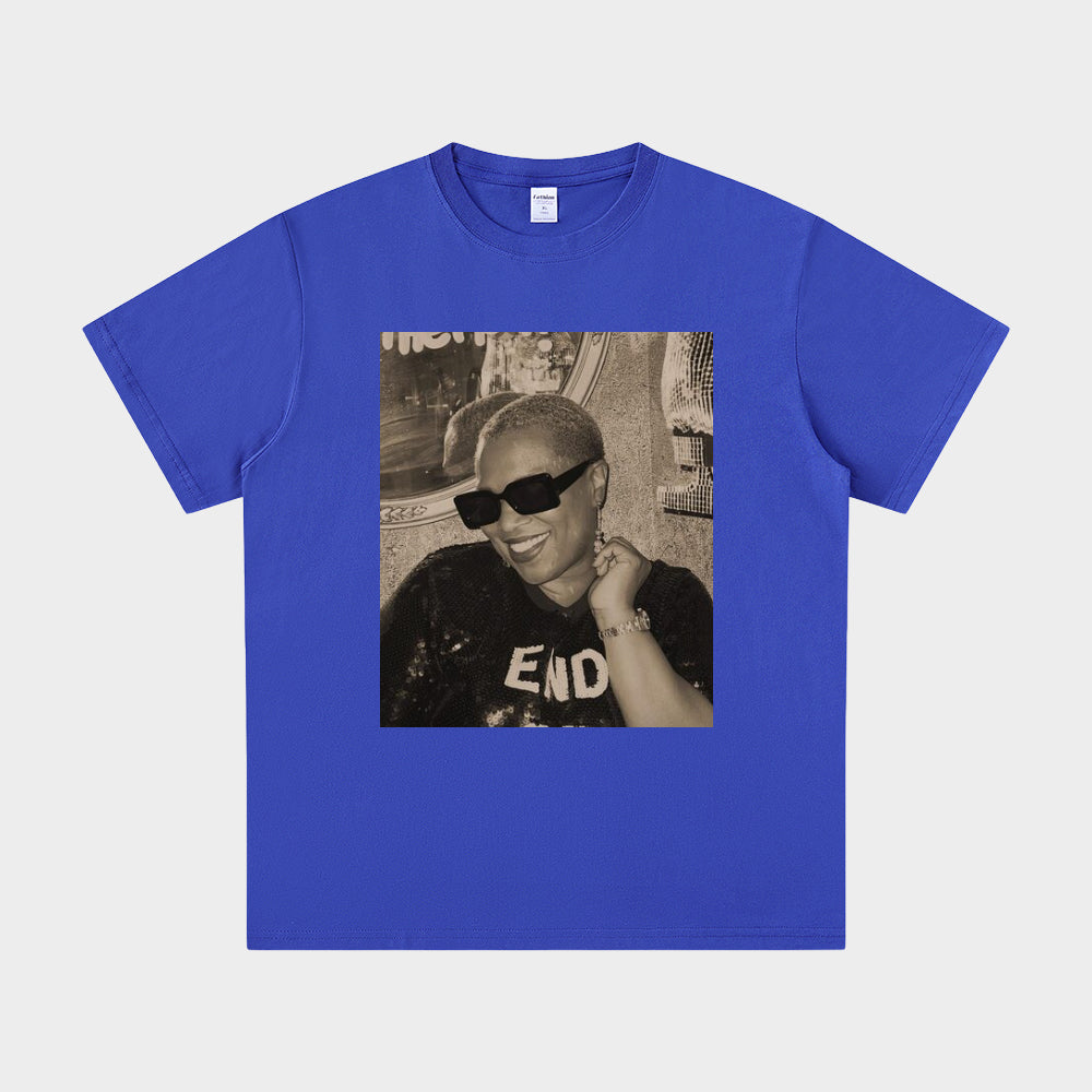 Blue t-shirt with a graphic of a person wearing sunglasses and a cap on a white background