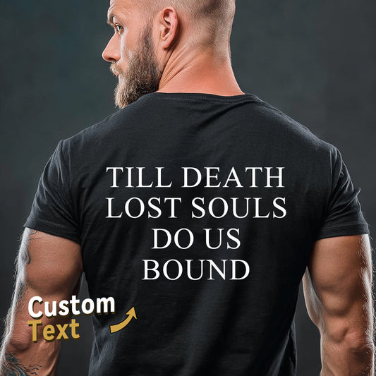 Man wearing a black t-shirt with text on the back against a dark background