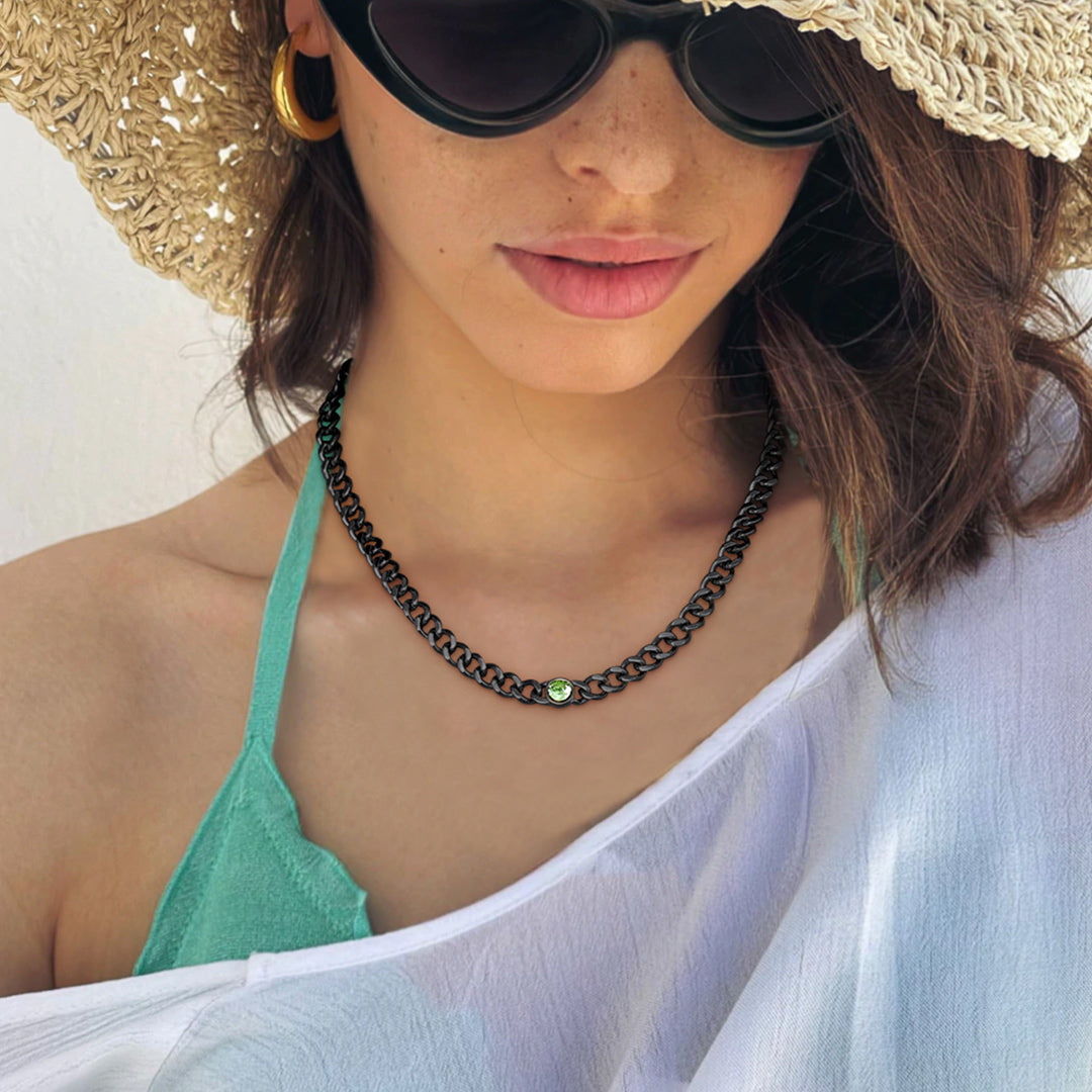 Female model styling may birthstone necklace in black