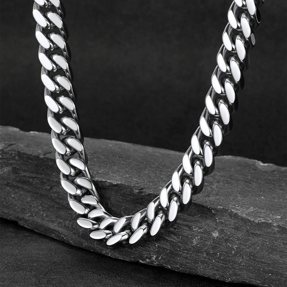 Chunky Cuban link choker necklace laid flat on white background, thick statement chain