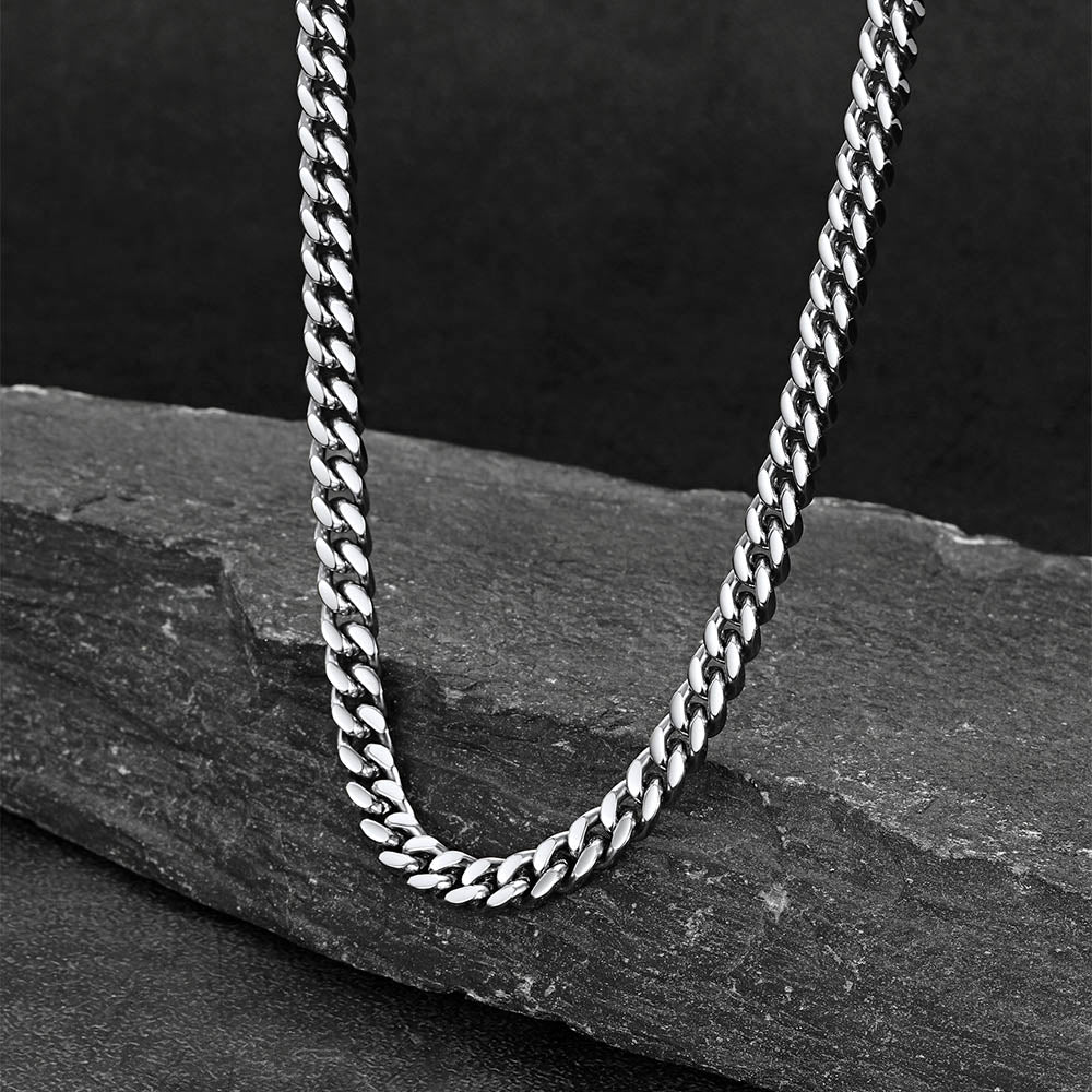 Chunky Cuban link choker necklace laid flat on white background, thick statement chain