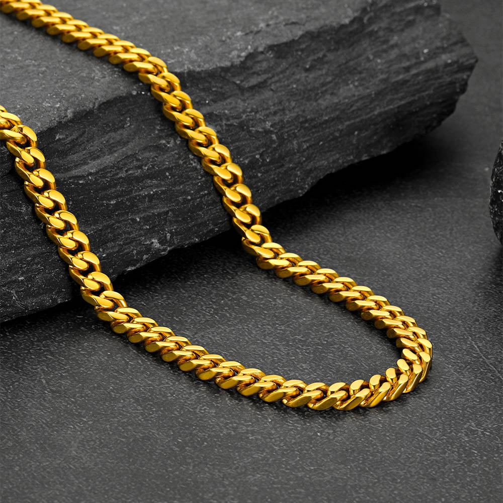 Chunky Cuban link choker necklace laid flat on white background, thick statement chain