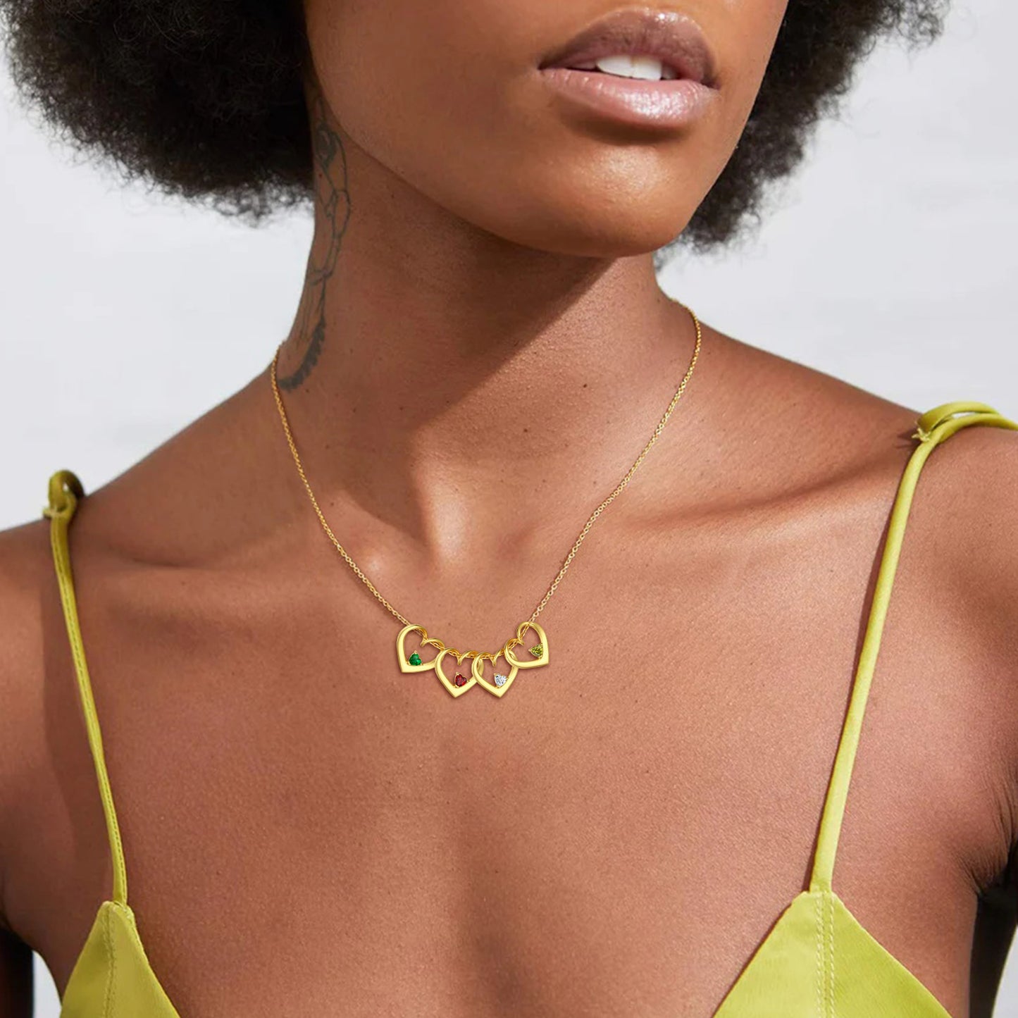 Woman wearing a gold Heart Birthstone Necklace