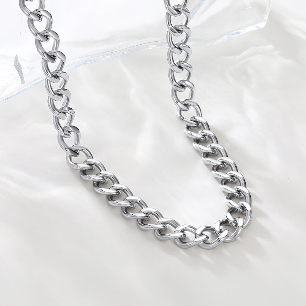 Silver chain necklace on a light gray background