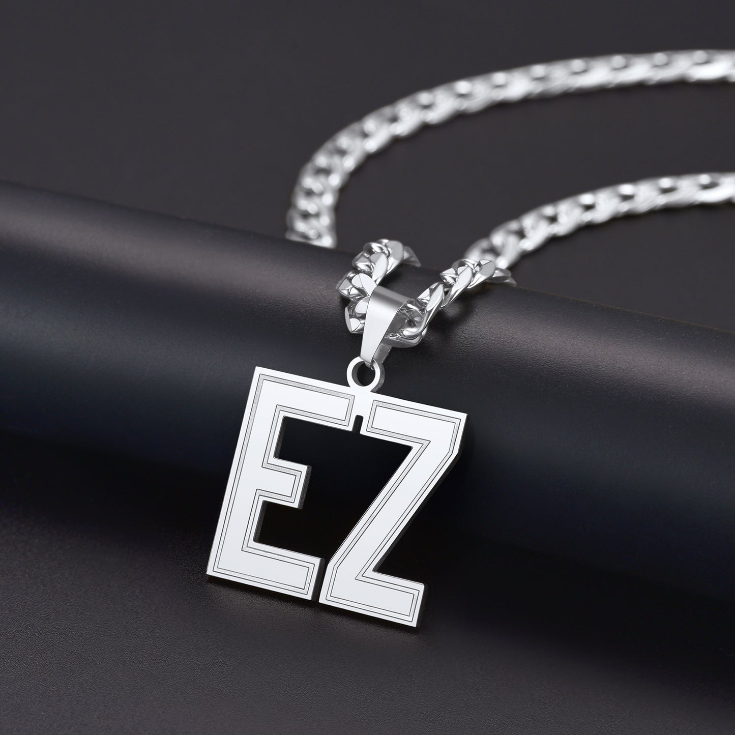 Silver necklace with a Initial Letter Necklace featuring the letters 'EZ' on a dark background