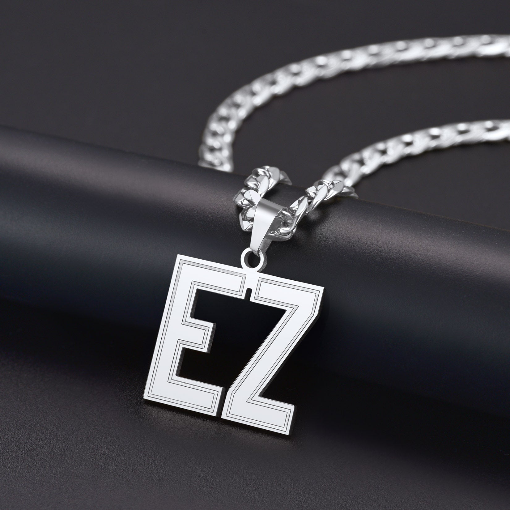 Silver necklace with a Initial Letter Necklace featuring the letters 'EZ' on a dark background