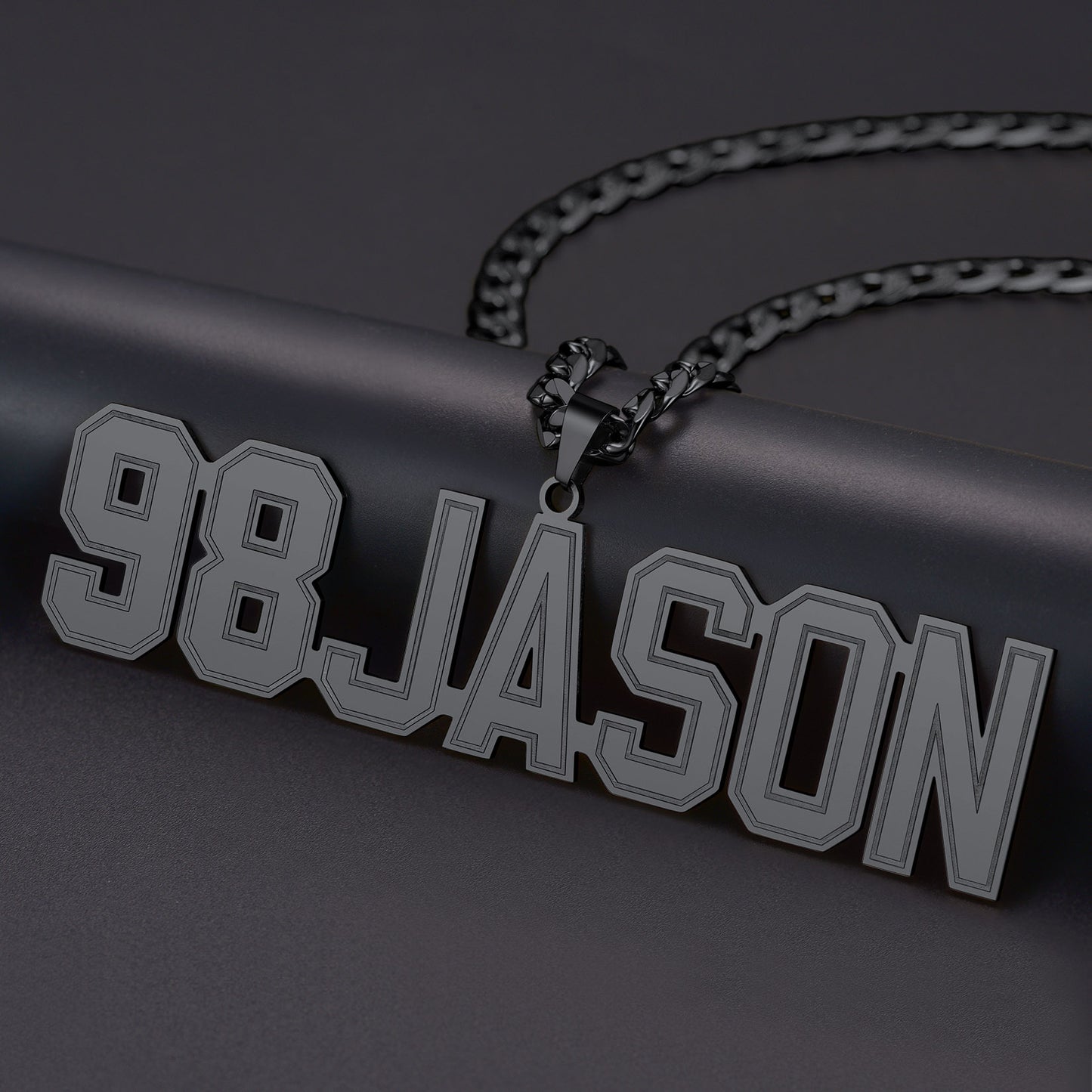 Black  Initial Letter necklace with '98JASON' pendant on a dark background