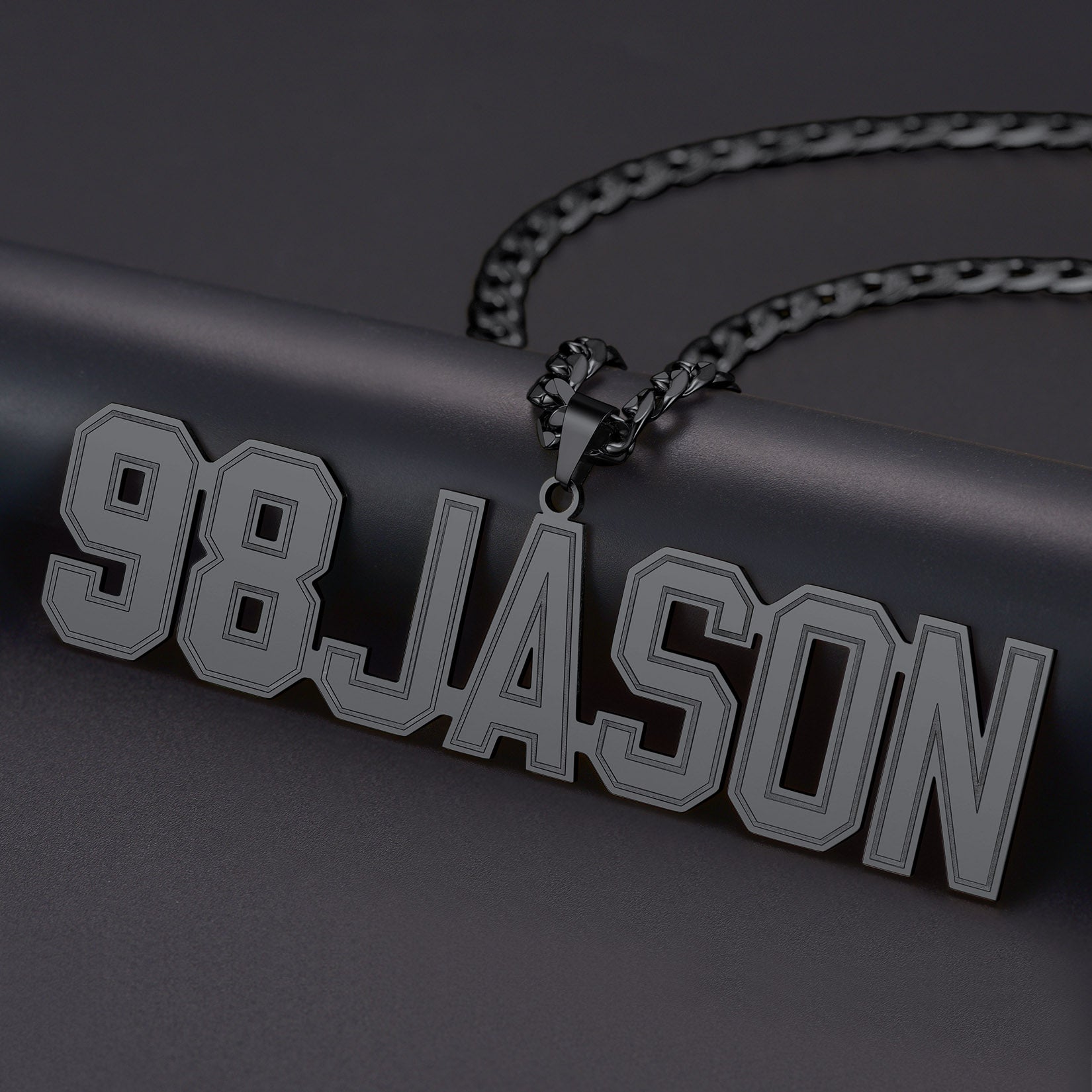 Black  Initial Letter necklace with '98JASON' pendant on a dark background