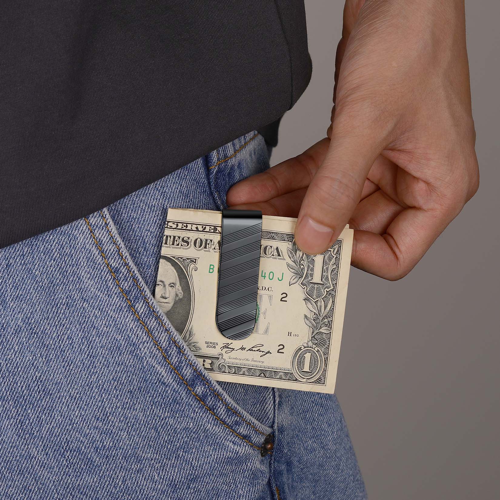 Man holding Minimalist Money Clip with dollar bills in his pocket