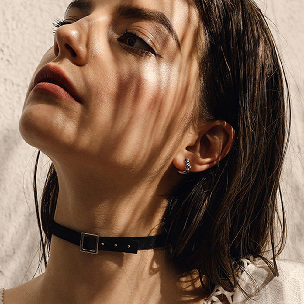 Woman wearing sterling silver chunky rose hoop earrings