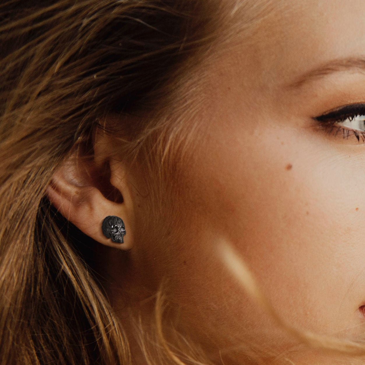 Gothic Flaming Skull Stud Earring on ear