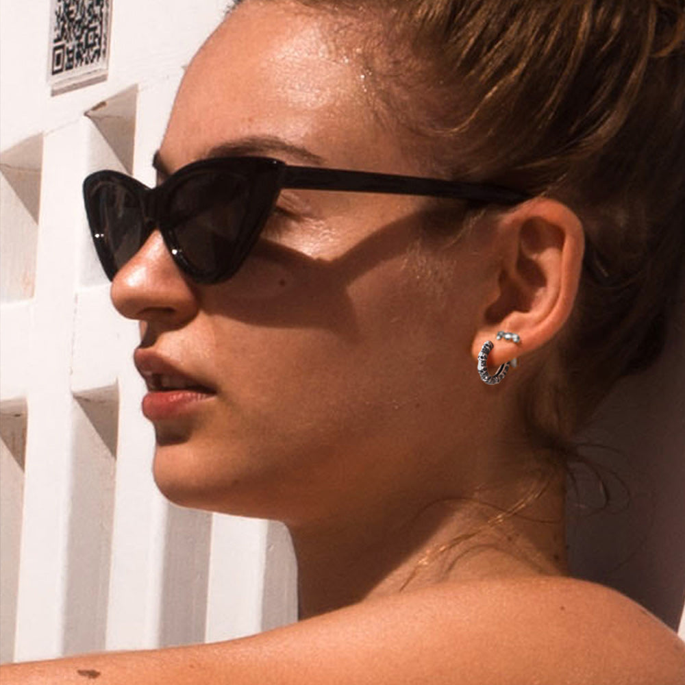 Girl Wearing Gothic Skull Steel Hoop Earrings