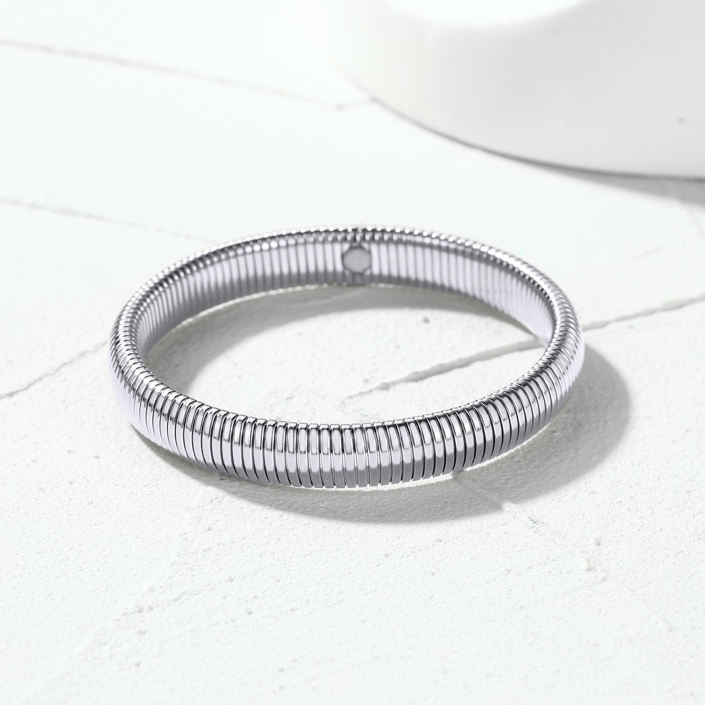 Close-up view of polished stainless steel stretch chain bangle links