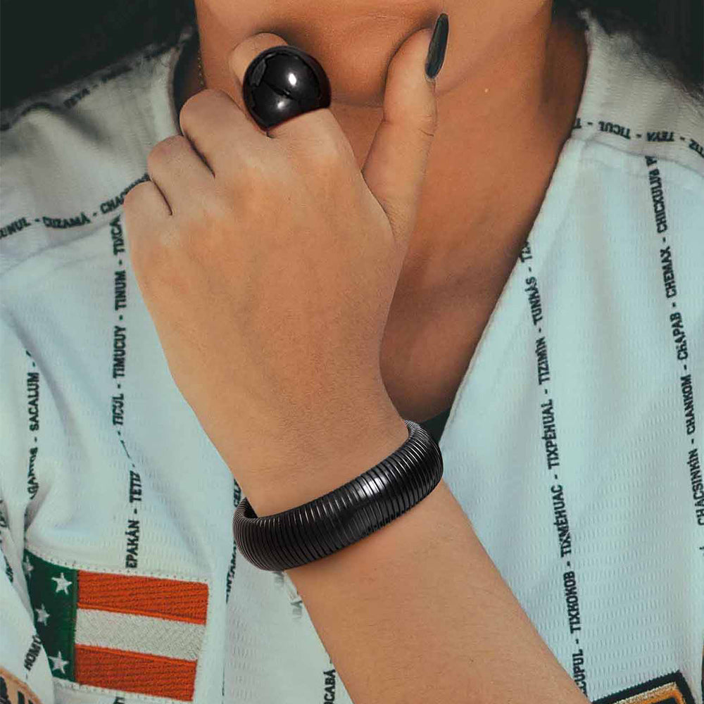 Man wearing wide stainless steel stretch chain bangle bracelet with casual outfit