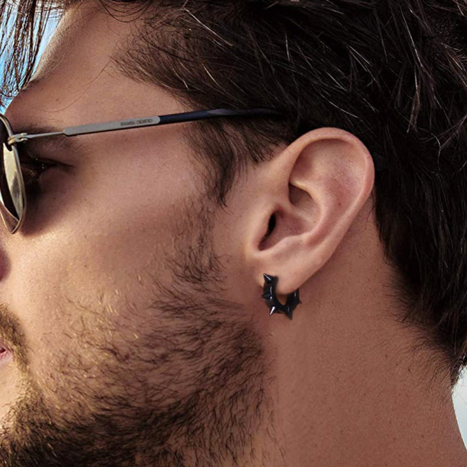 Man wearing a black punk spike huggie hoop earring