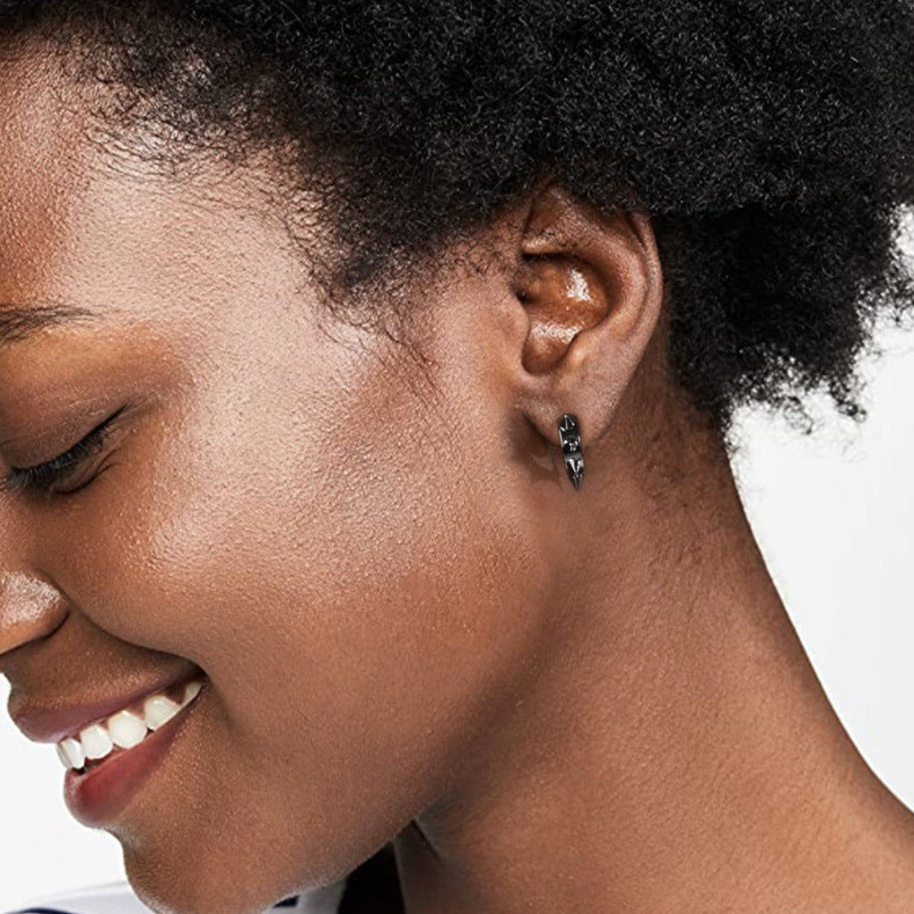 Punk spike huggie hoop earring on ear