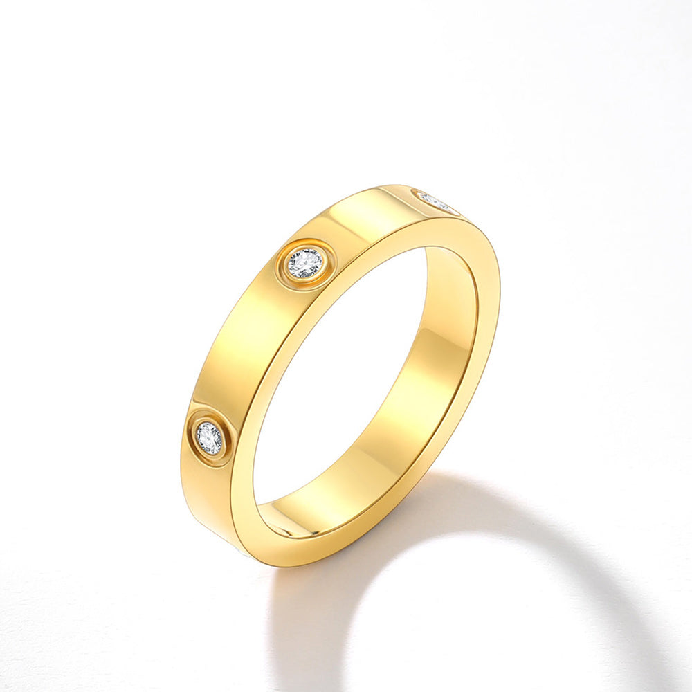 Gold ring with embedded diamonds on a white background