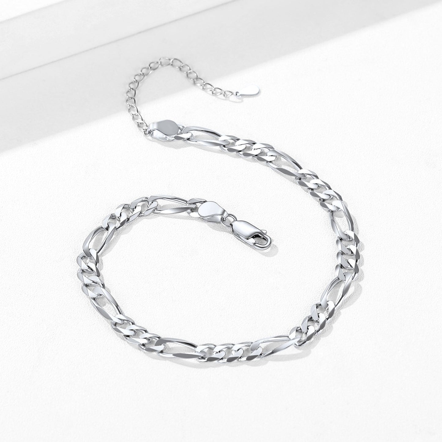 Lobster clasp detail on Figaro chain ankle bracelet