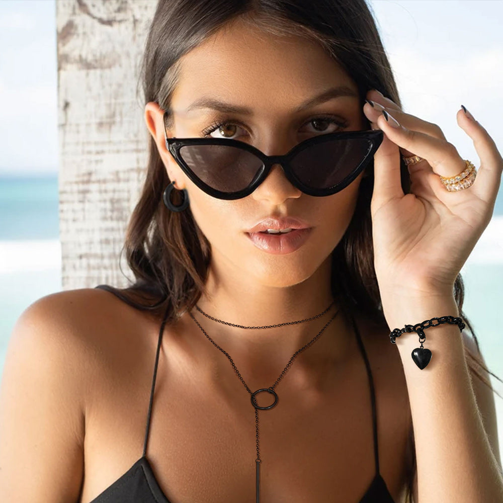Woman wearing black heart bracelet and necklace